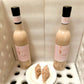 Displayed in a foam-padded box are two bottles of Loudyvie’s Kremas by Loudyvie's. In front of the bottles, a white plate holds two triangular slices of homemade eggnog dessert. The setup highlights the Kremas and the dessert within a secure, cushioned environment.